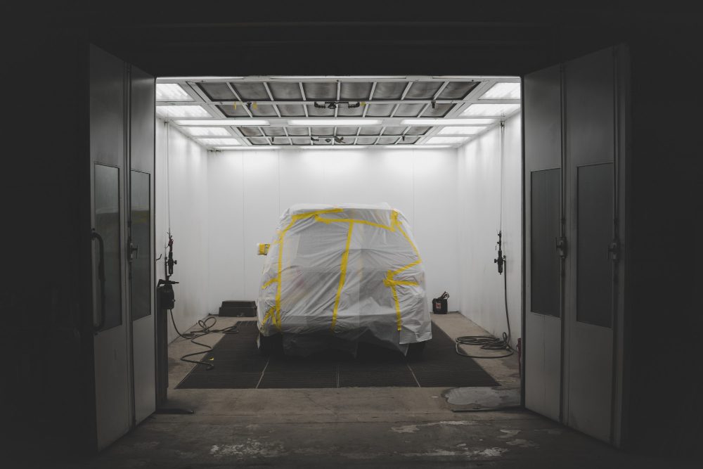vehicle covered with white sheet yellow tape car service garage 1