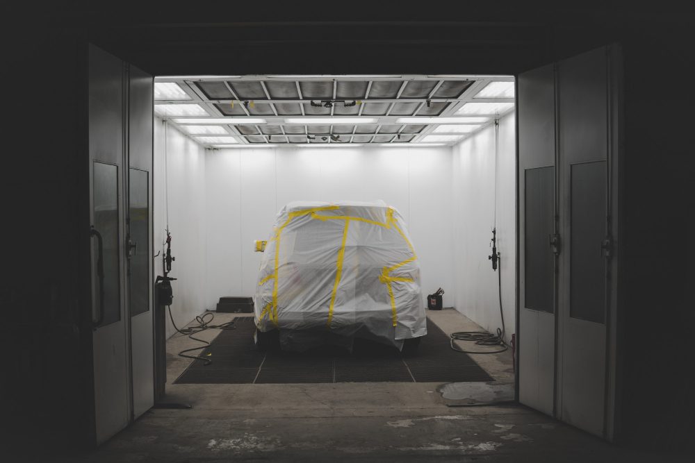 vehicle covered with white sheet yellow tape car service garage 1 1